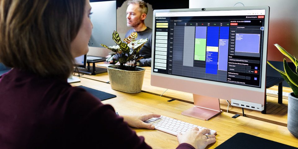 Filmmakers organizing video footage and audio files on a digital media management platform